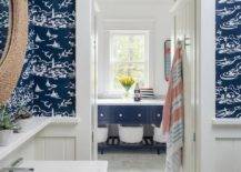 blue sailboat wallpaper in bathroom with white trim rope round mirror sink