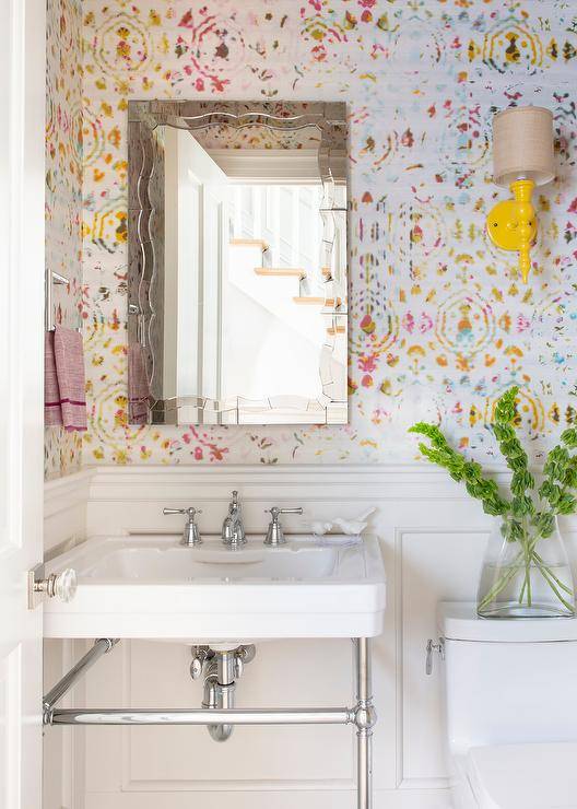 bold color wallpaper in half bathroom with yellow wall sconce pedestal sink