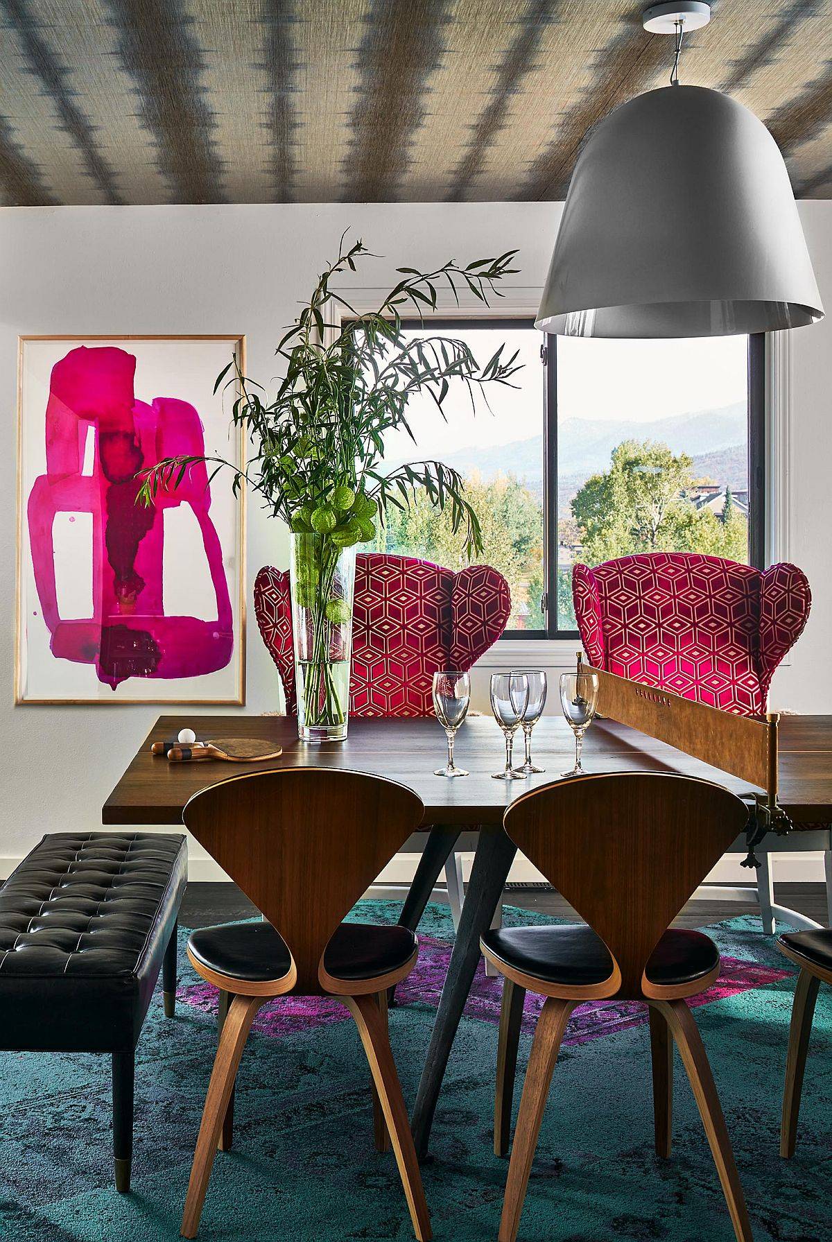 Captivating pops of fuchsia in the wall art piece accentuate the pink presence in this dining room