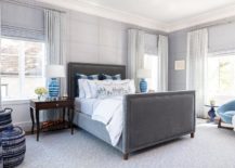 charcoal grey navy and blue color scheme bedroom with velvet headboard checker wallpaper