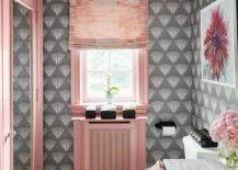 Pink and gray bathroom features gray wallpaper and a pink ceiling, pink closet doors, a gray marble sink vanity and white, gray and gold chevron marble floor tiles.
