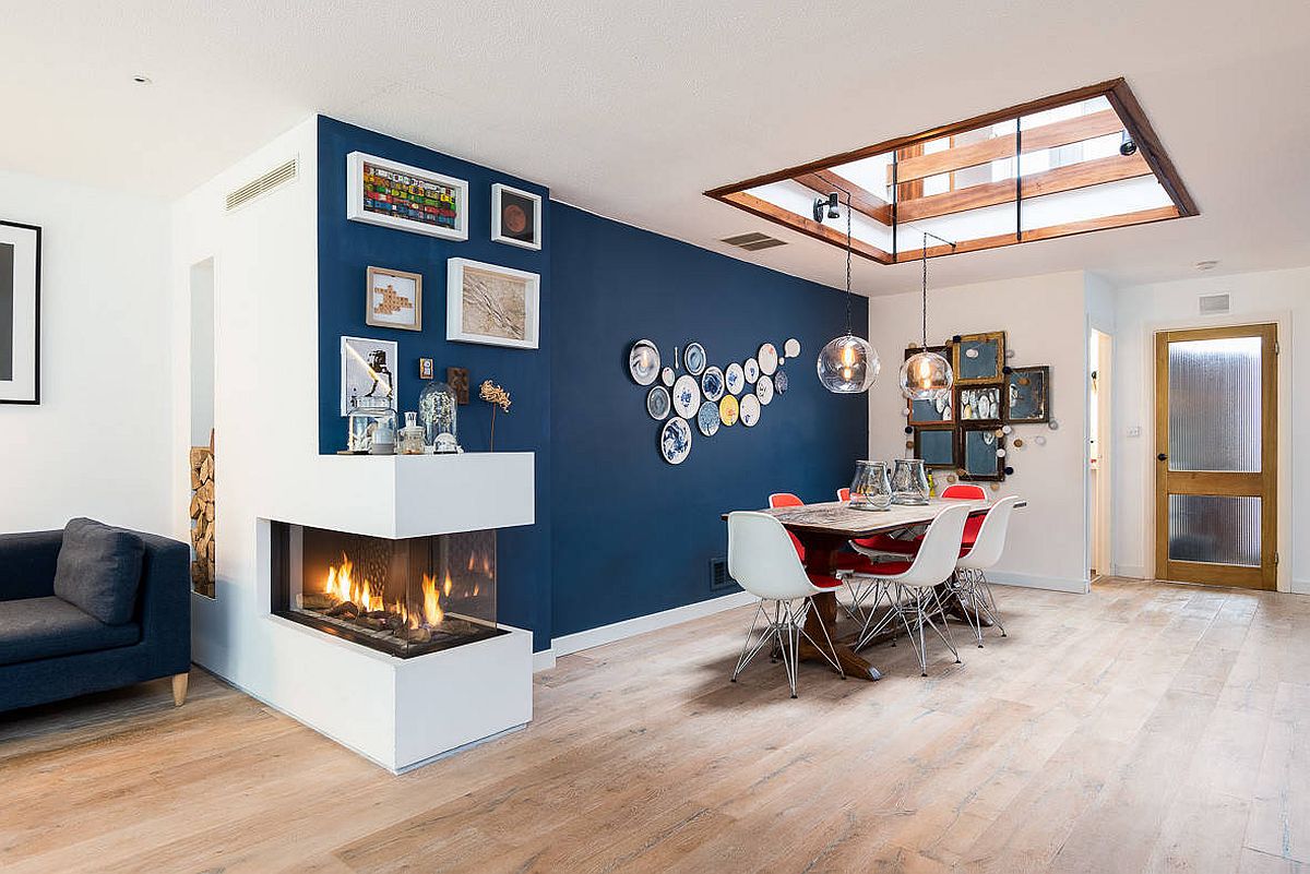 Delightful-blue-accent-wall-skylight-and-a-double-sided-fireplace-brighten-this-dining-room-57176