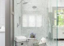 Bathroom features a marble shower with his and hers shower heads, a clear partition and a vintage radiator.