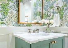 green vanity with floral wallpaper and gold arch mirror flowers white marble top sink