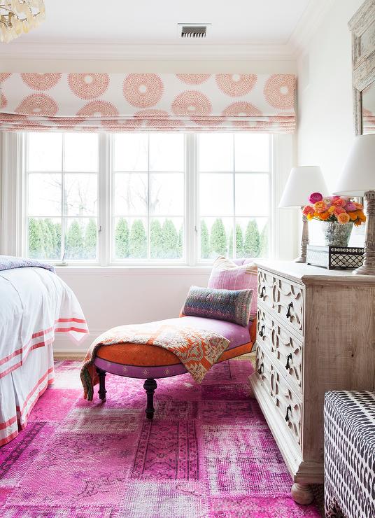 pink orange and purple theme bedroom with chaise lounge wood dresser roman blinds big window