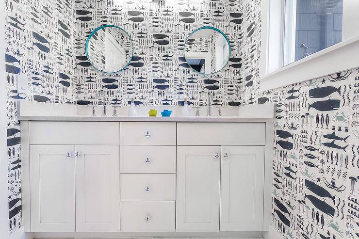 Blue and white contemporary boys' bathroom with under-the-sea animal wallpaper, turquoise vanity mirrors over white vanity cupboards