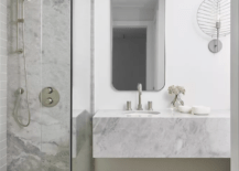 mixed marble textures basement bathroom long mirror silver accents walk in shower